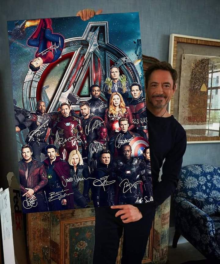 Robert Downey Jr. with Avengers poster