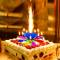 Magic Birthday Candle How about not using normal candles on birthday cakes but these magic candles to wow someone on his/her birthday? This interesting candle displays itself as a closed flower bud initially. After lighting the candles, it will open up, shoot fireworks and play